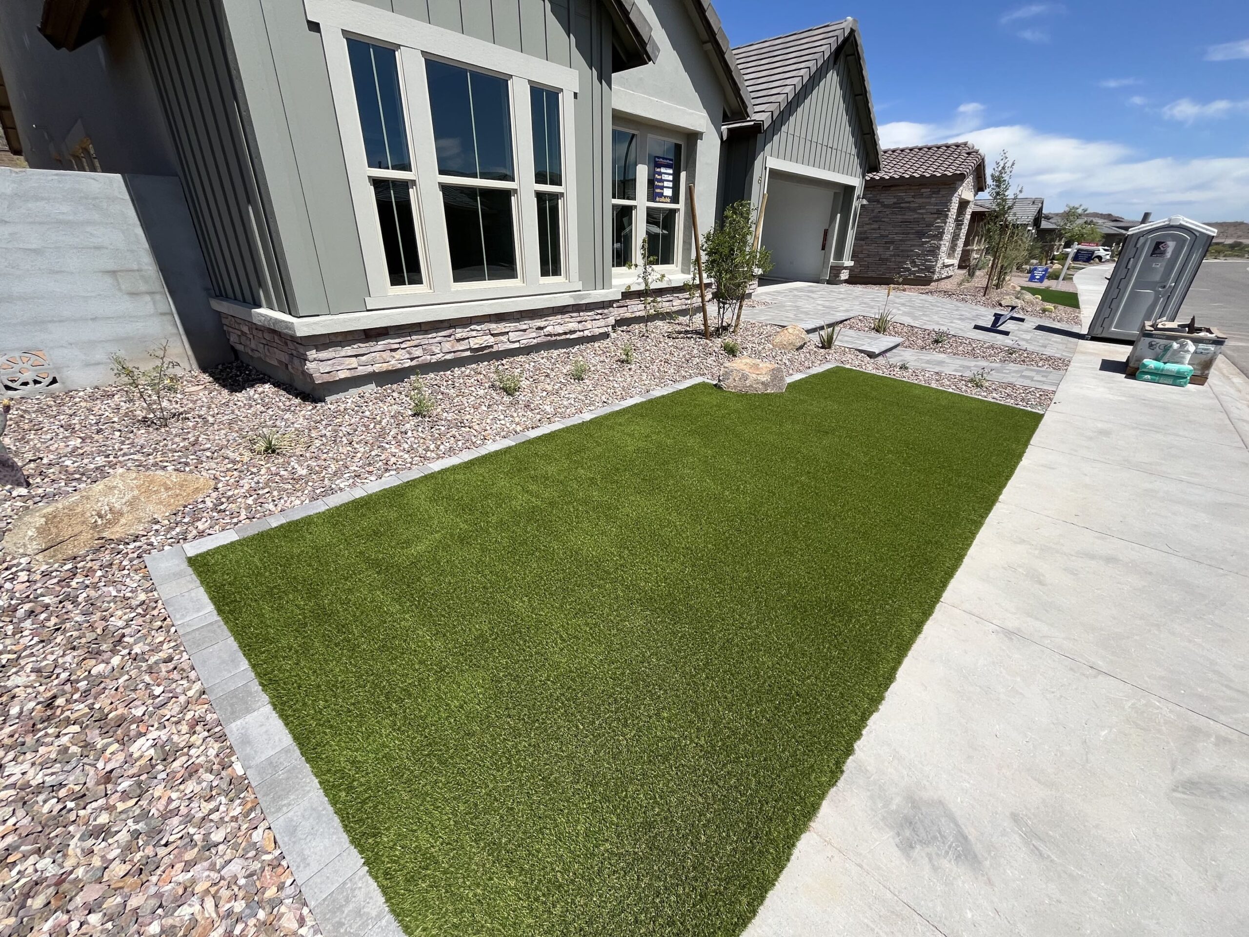 Artificial turf in Arizona front yard with windows demonstrating reflections